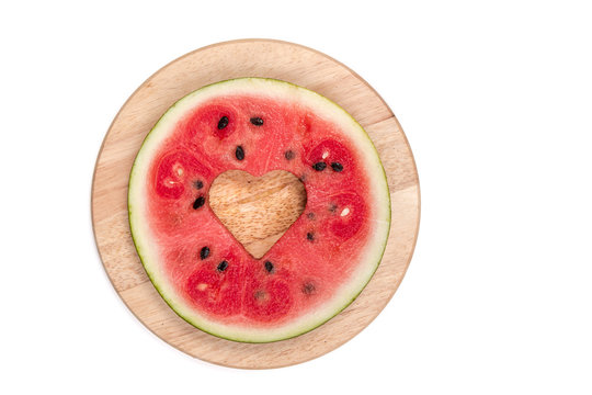 cut watermelon on wooden board isolated