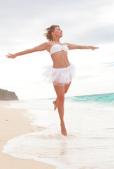 Happy Woman jumping on beach