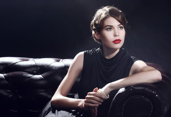 Young beautiful woman in black dress