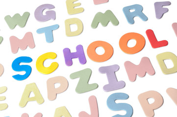Foam letters forming the word School, isolated on white background.