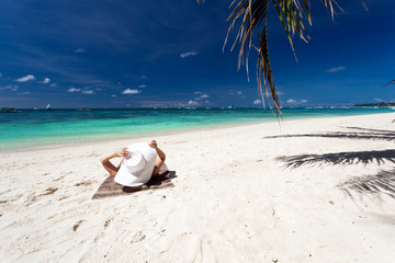 Fototapeta na wymiar Woman relaxing on beach