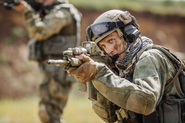 Portrait of a ranger in the battlefield with a gun