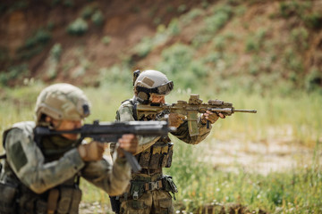 Fototapeta premium Portrait of a ranger in the battlefield with a gun