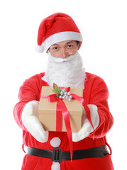 Christmas theme: Santa Claus asian holding and offering a gift o
