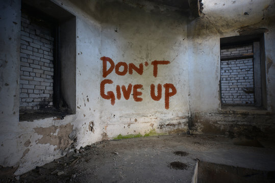 text dont give up on the dirty old wall in an abandoned ruined house