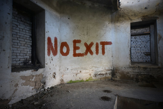 text no exit on the dirty old wall in an abandoned ruined house