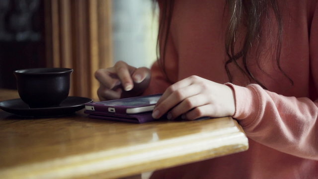 Woman scrolling websites on tablet and surfing on internet
