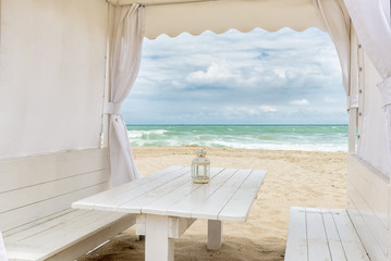 Seashore view through a white tent