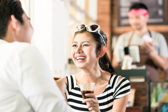 Asian Couple In Cafe Flirting While Drinking Coffee