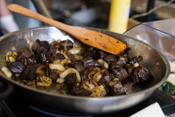 Mushrooms and Onions Cooking in Metal Frying Pan