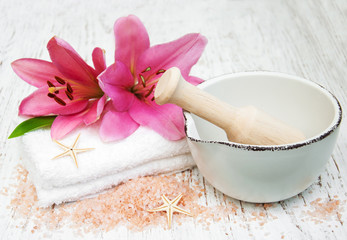Pink lily, towels and sea salt