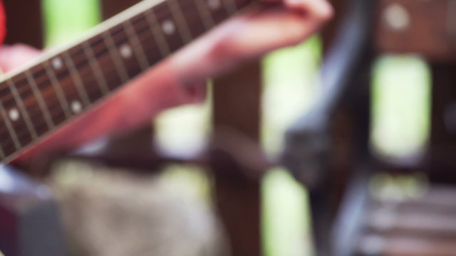 Woman playing on the guitar and creating something
