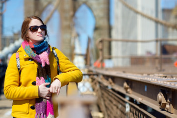 Young woman sightseeing on Brooklyn Bridge