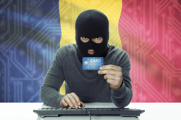 Dark-skinned hacker with flag on background holding credit card - Chad