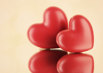 Fototapeta premium Red hearts on light background