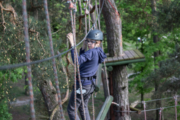 teenager climbing a rope park, Girl climbing in adventure park  