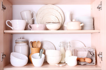 Kitchen utensils and tableware on shelves