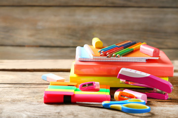 Bright school stationery on old wooden table