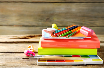 Bright school stationery on old wooden table