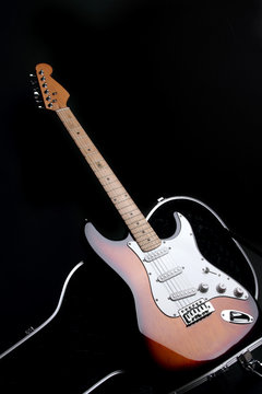 Electric guitar in guitar case, on black background