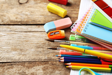 Obraz premium Bright school stationery on old wooden table