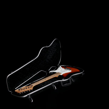 Electric guitar in guitar case, on black background