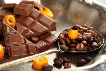 Chocolate with orange peels and coffee beans in metal tray
