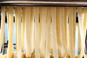 Making noodles with pasta machine, closeup