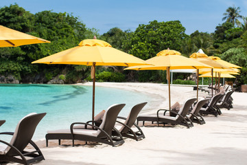 Sun umbrellas and beach chairs on beach