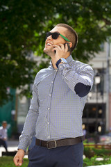 Happy young men calling by phone