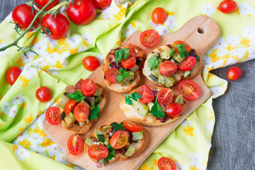 Bruschetta with zucchini, bacon, green onions and cherry tomatoe