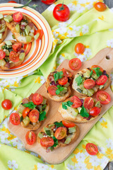 Bruschetta with zucchini, bacon, green onions and cherry tomatoe