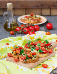 Bruschetta with zucchini, bacon, green onions and cherry tomatoe