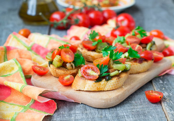Bruschetta with zucchini, bacon, green onions and cherry tomatoe