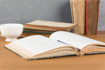 old book with pencil and coffee
