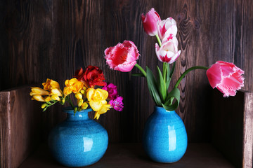 Fresh spring flowers on wooden background