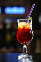 Glass of cocktails on bar background