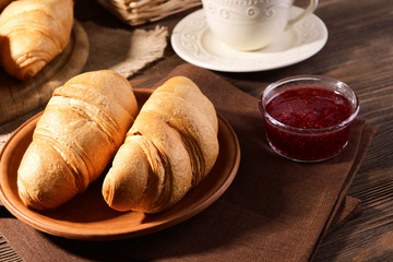 Delicious croissants on plate on table close-up