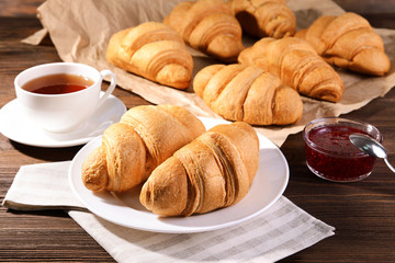 Delicious croissants on plate on table close-up