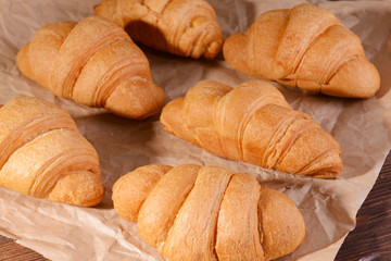 Delicious croissants on table close-up