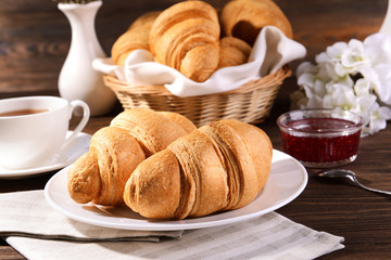 Delicious croissants on plate on table close-up