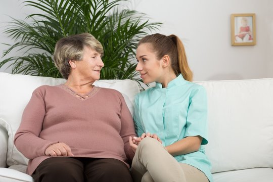 Retired woman talking with nurse