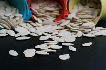 Pumpkin seeds on a black background