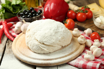 Food ingredients for pizza on table close up