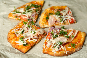 Tasty pizza on paper close up