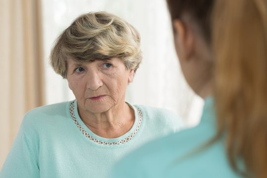 Sad senior female in nursing home