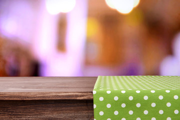 Empty wooden table with napkin and light background