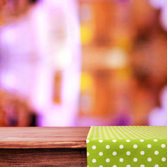 Empty wooden table with napkin on light background