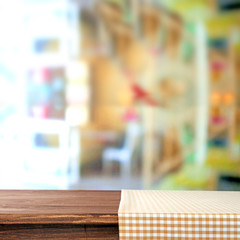 Empty wooden table with napkin on light background