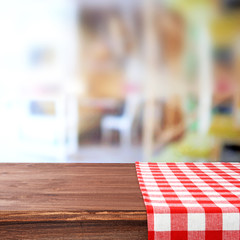 Empty wooden table with napkin on light background